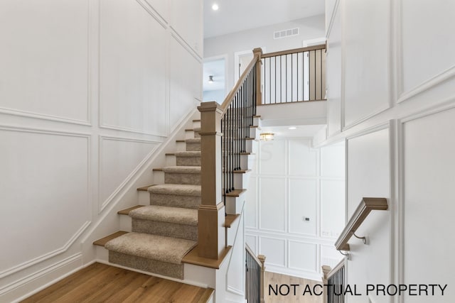 stairs featuring hardwood / wood-style flooring