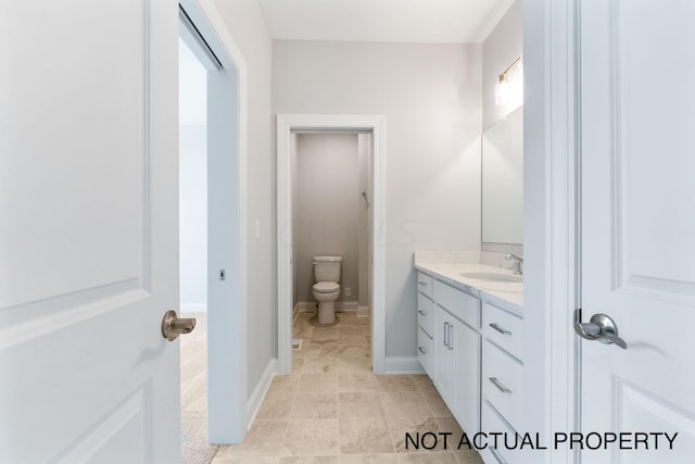 bathroom featuring vanity and toilet