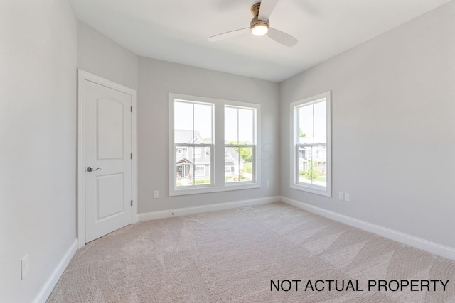 carpeted empty room with ceiling fan