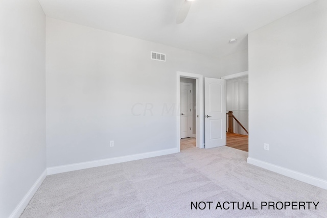 spare room featuring light carpet