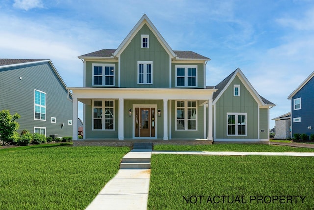 view of front of property featuring a front yard and covered porch