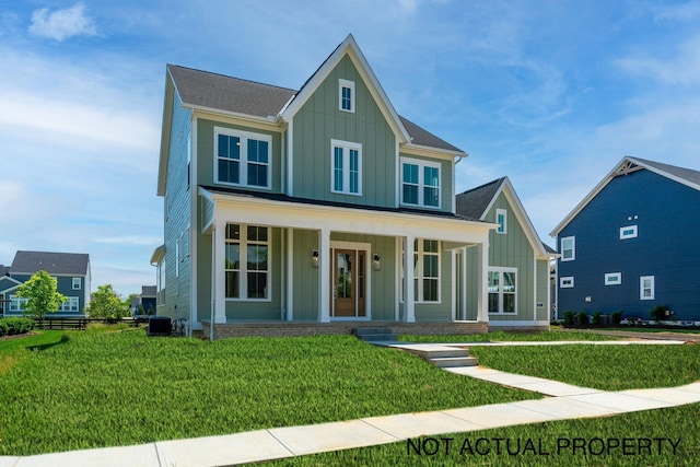 view of front of property featuring a porch, a front lawn, and cooling unit