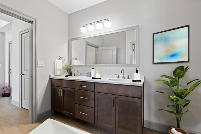 bathroom with vanity and hardwood / wood-style flooring