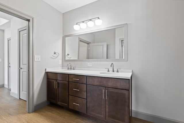 bathroom with hardwood / wood-style floors and vanity