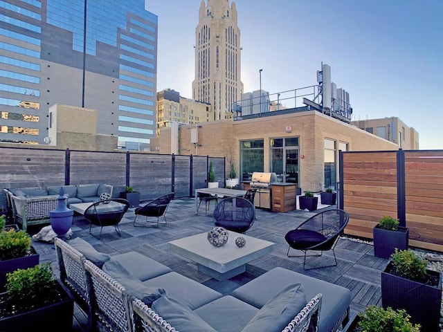 view of patio with area for grilling and an outdoor living space with a fire pit