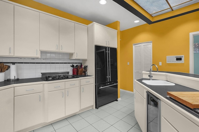 6730 Dublin Rd, Dublin, OH 43017 - kitchen with decorative backsplash, sink, black appliances, white cabinets, and wine cooler