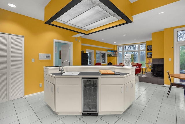 6730 Dublin Rd, Dublin, OH 43017 - kitchen featuring white cabinets, wine cooler, a kitchen island with sink, and plenty of natural light