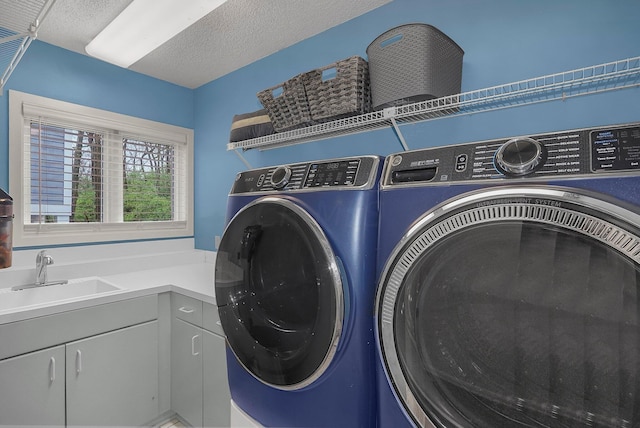 6730 Dublin Rd, Dublin, OH 43017 - clothes washing area with cabinets, a textured ceiling, sink, and washing machine and clothes dryer