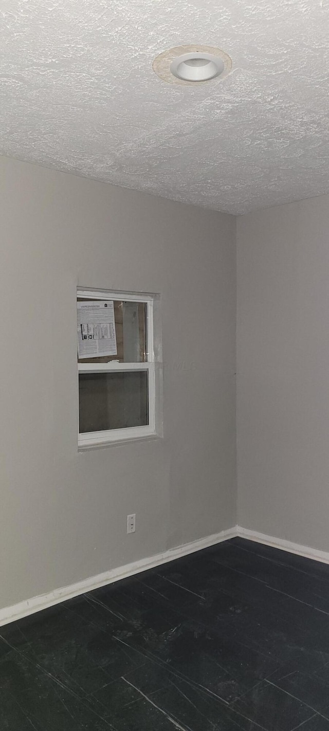 empty room featuring a textured ceiling