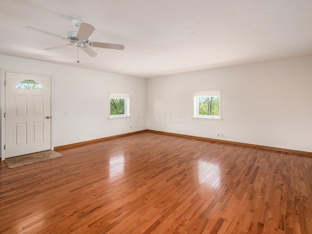 interior space with ceiling fan, a healthy amount of sunlight, and hardwood / wood-style flooring