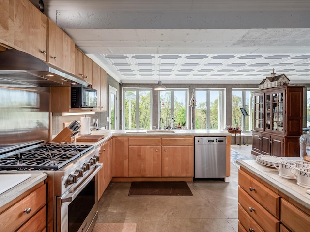 kitchen featuring pendant lighting, sink, and appliances with stainless steel finishes