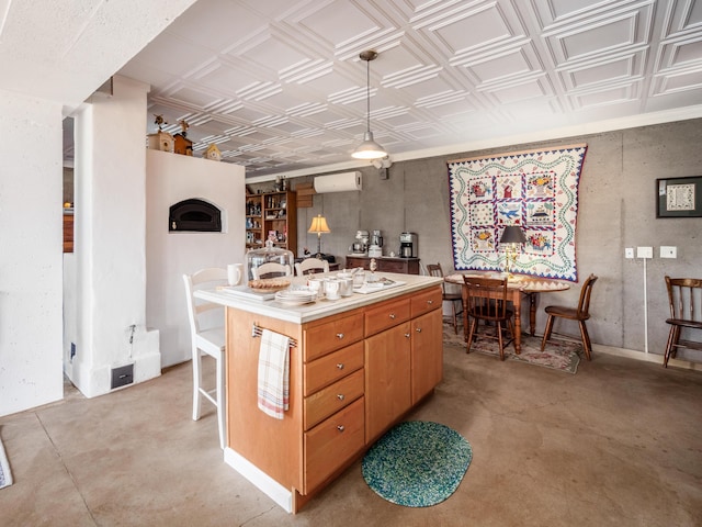 kitchen featuring a wall mounted air conditioner, a kitchen island, and hanging light fixtures