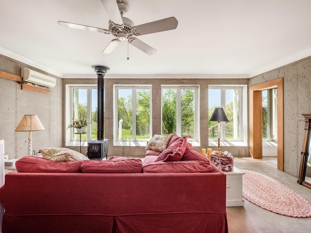 living room featuring a wood stove, a wall mounted AC, crown molding, and ceiling fan