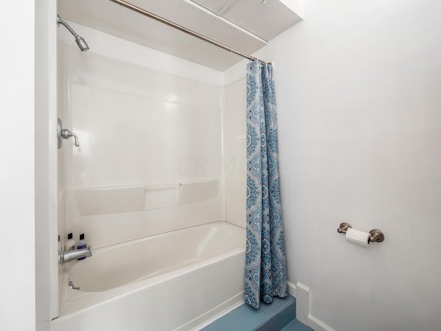 bathroom with shower / bath combo with shower curtain