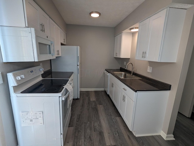 kitchen featuring sink, white cabinets, dark hardwood / wood-style floors, and white appliances