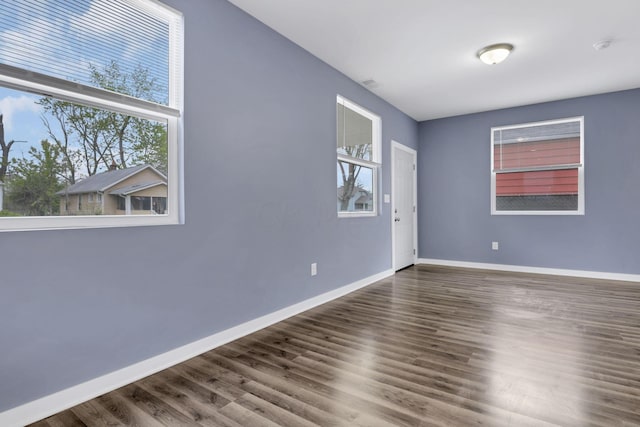 empty room with hardwood / wood-style flooring