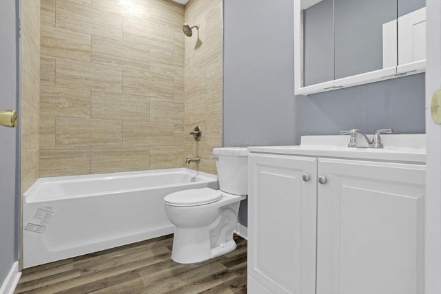 full bathroom with hardwood / wood-style floors, vanity, toilet, and tiled shower / bath combo