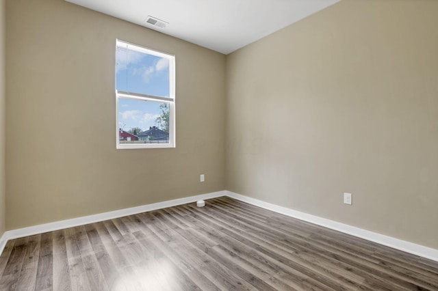 empty room with hardwood / wood-style flooring