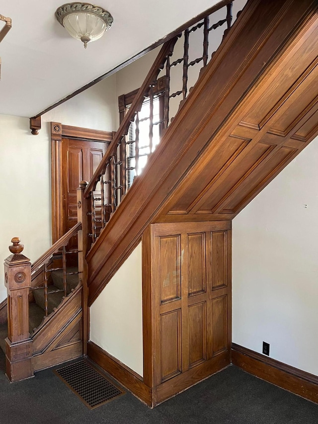 staircase with carpet flooring and vaulted ceiling