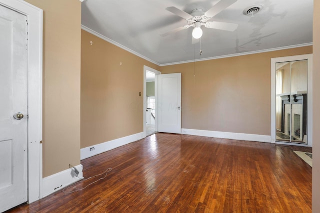 empty room featuring dark hardwood / wood-style floors, ceiling fan, and crown molding