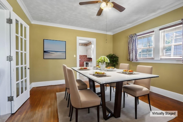 dining room featuring dark hardwood / wood-style floors, ceiling fan, crown molding, and french doors