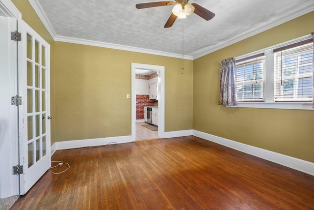 spare room featuring hardwood / wood-style floors, french doors, crown molding, ceiling fan, and a textured ceiling