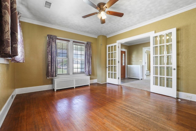 spare room featuring radiator, hardwood / wood-style floors, and french doors