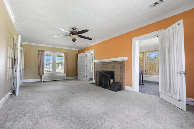 unfurnished living room with crown molding, a fireplace, and light colored carpet