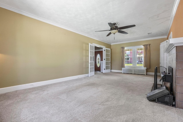 unfurnished living room featuring light carpet, french doors, ceiling fan, and ornamental molding