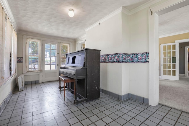 misc room with tile patterned floors, a textured ceiling, and ornamental molding