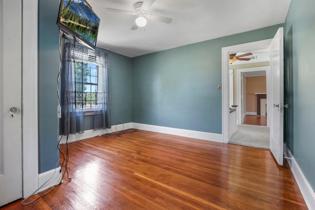 unfurnished room with ceiling fan and hardwood / wood-style floors