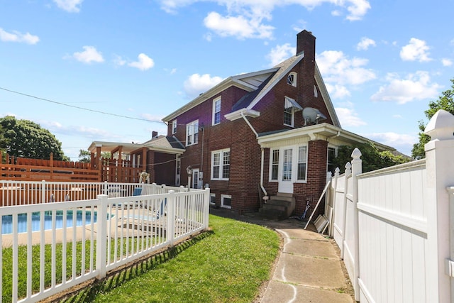 view of side of property with a yard