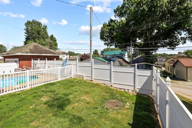 view of yard with a fenced in pool