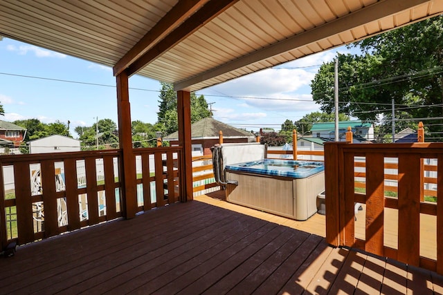 wooden terrace featuring a hot tub