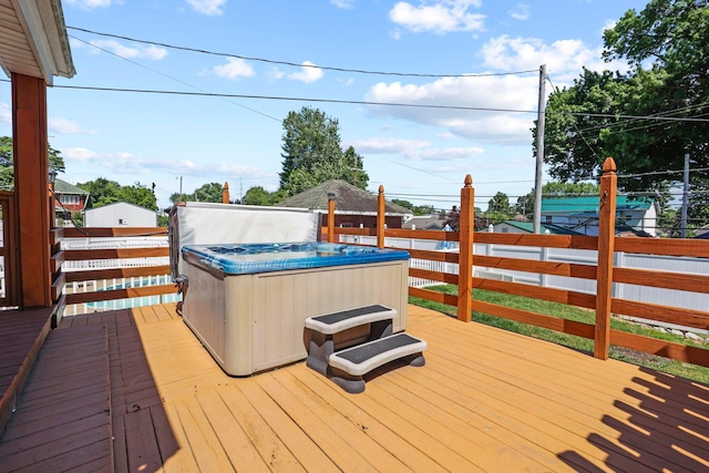 wooden deck featuring a hot tub