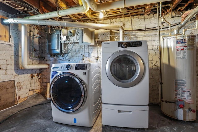 clothes washing area featuring separate washer and dryer, electric panel, and water heater