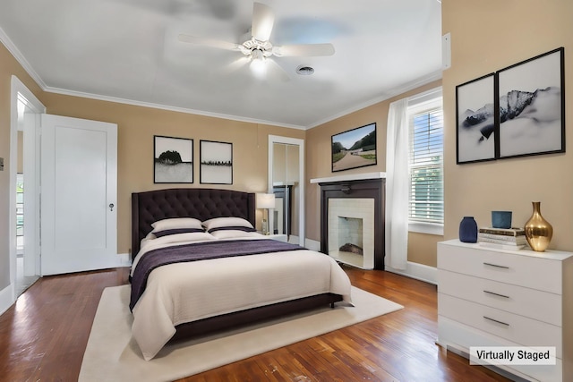 bedroom featuring ceiling fan, wood-type flooring, and crown molding