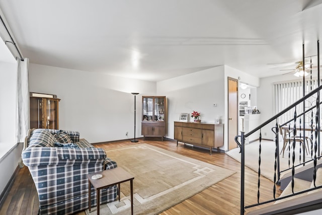 living room with ceiling fan and hardwood / wood-style flooring