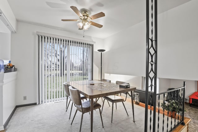 carpeted dining space featuring ceiling fan