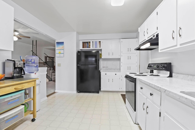 kitchen featuring electric range, white cabinetry, black fridge, and ceiling fan