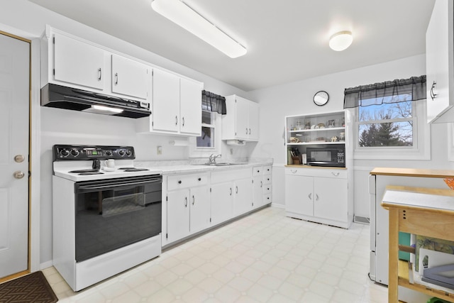 kitchen with white cabinetry, electric range, and sink