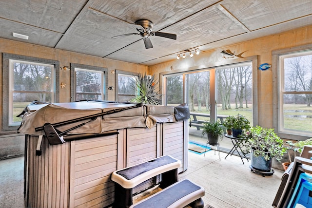 sunroom with a hot tub, ceiling fan, and a healthy amount of sunlight