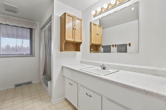 bathroom featuring shower / bathtub combination with curtain and vanity