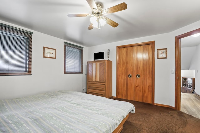 carpeted bedroom featuring a closet and ceiling fan