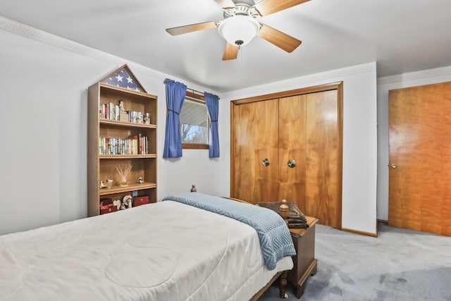 carpeted bedroom with ceiling fan and a closet