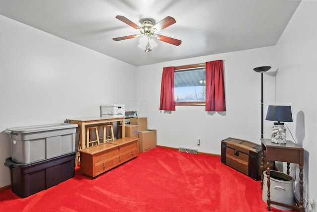 miscellaneous room with ceiling fan and carpet