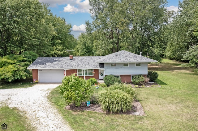 split level home with a front yard and a garage