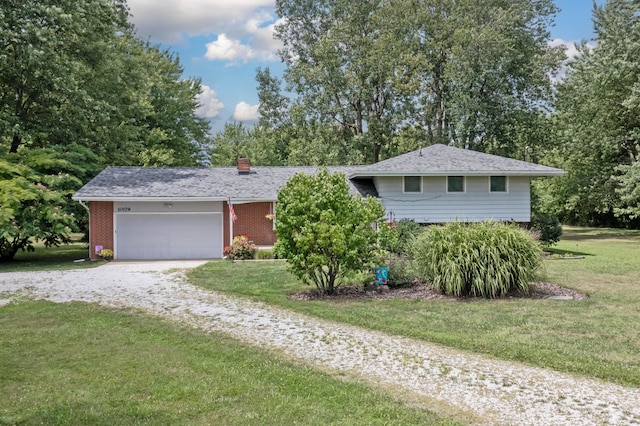 ranch-style house with a garage and a front lawn