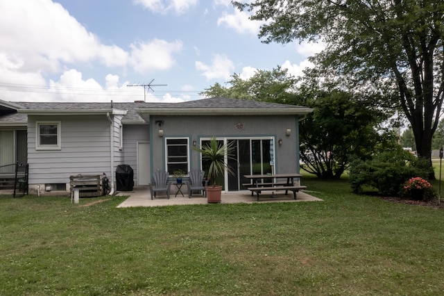 rear view of house with a patio area and a lawn