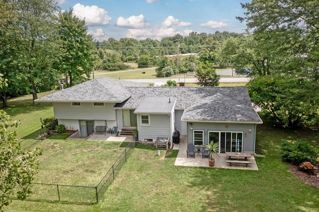 back of house with a lawn and a patio